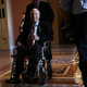 Sen. John McCain (R-Ariz.) passes by on a wheelchair in a hallway at the Capitol on Dec. 1, 2017, in Washington, D.C.